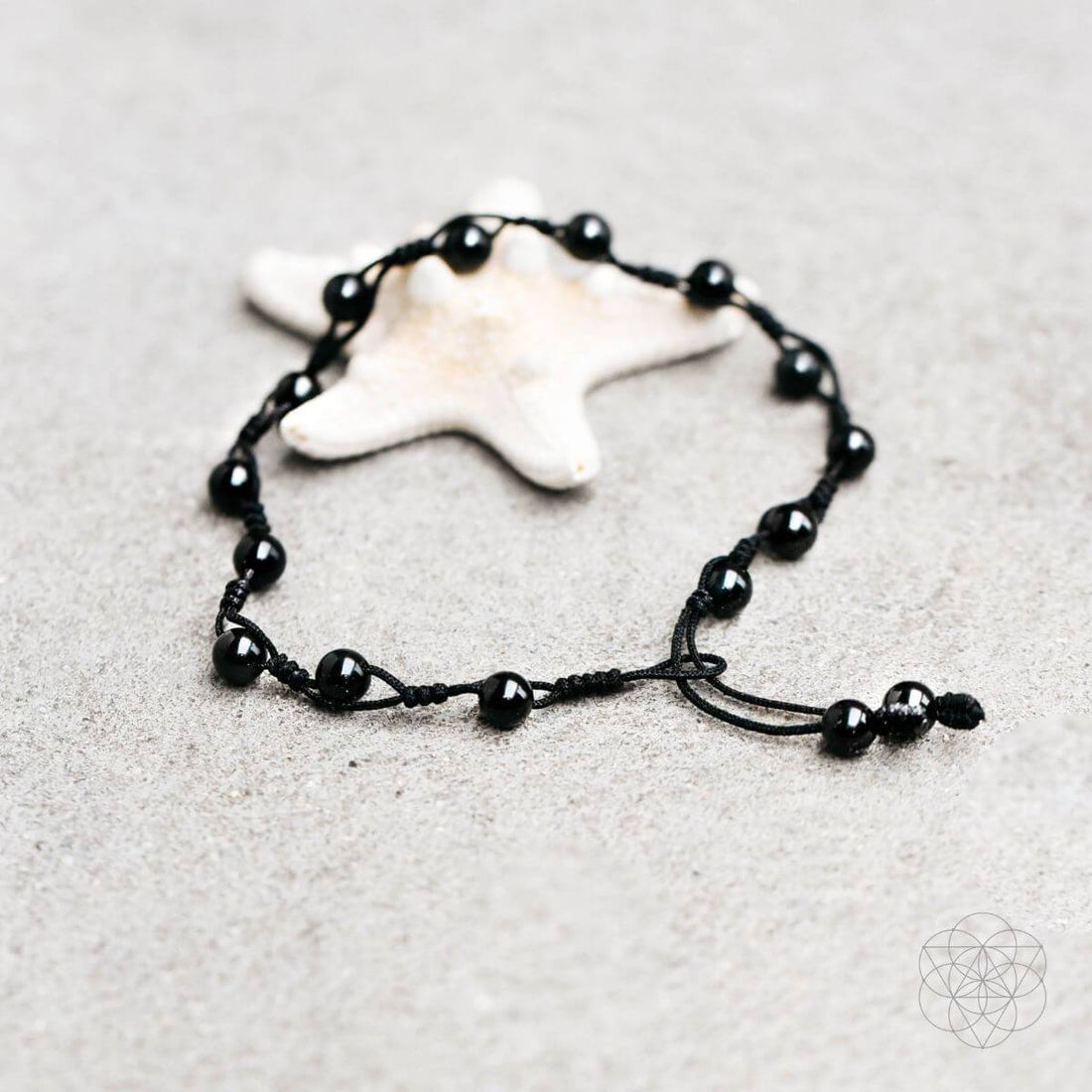 Black obsidian grounding anklet with small beads and adjustable chain, designed for spiritual balance and stylish jewelry.