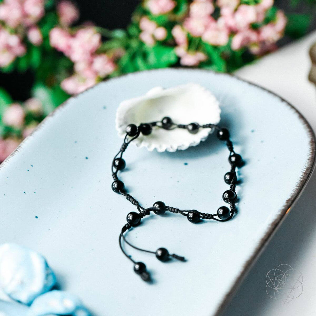 Black obsidian grounding anklet from Conscious Items featuring smooth, polished beads on a delicate silver chain.