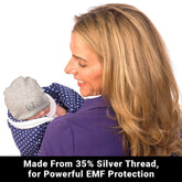 Blue baby beanie from Shield Your Body, designed for infants and toddlers, shown with a soft blanket in the background.