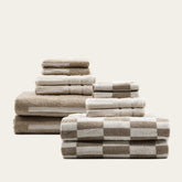 Set of Pietra Australian Cotton Towels by Italic, showcasing soft, plush white towels with textured weave pattern.