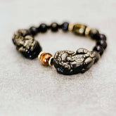 Conscious Items Pi Yao Wealth Bracelet featuring a gold-toned Pi Yao charm on a beaded bracelet for good luck and prosperity.