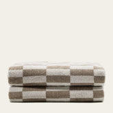 Italian Pietra Australian Cotton Bath Sheet by Italic, soft and plush white towel draped over a bathroom hook.