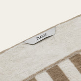Pietra Australian Cotton Bath Sheet by Italic, soft and plush white cotton towel draped on a bathroom hook.