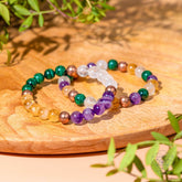 Jewelry set featuring four crystal bracelets for wealth manifestation by Conscious Items, with colorful beads and adjustable fits.