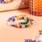 Jewelry set featuring four crystal bracelets for wealth manifestation, from Conscious Items, with colorful beads and elegant design.