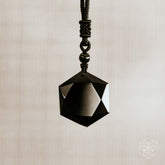 Black obsidian pendant necklace featuring a polished talisman from Conscious Items, showcasing a sleek, natural stone design.