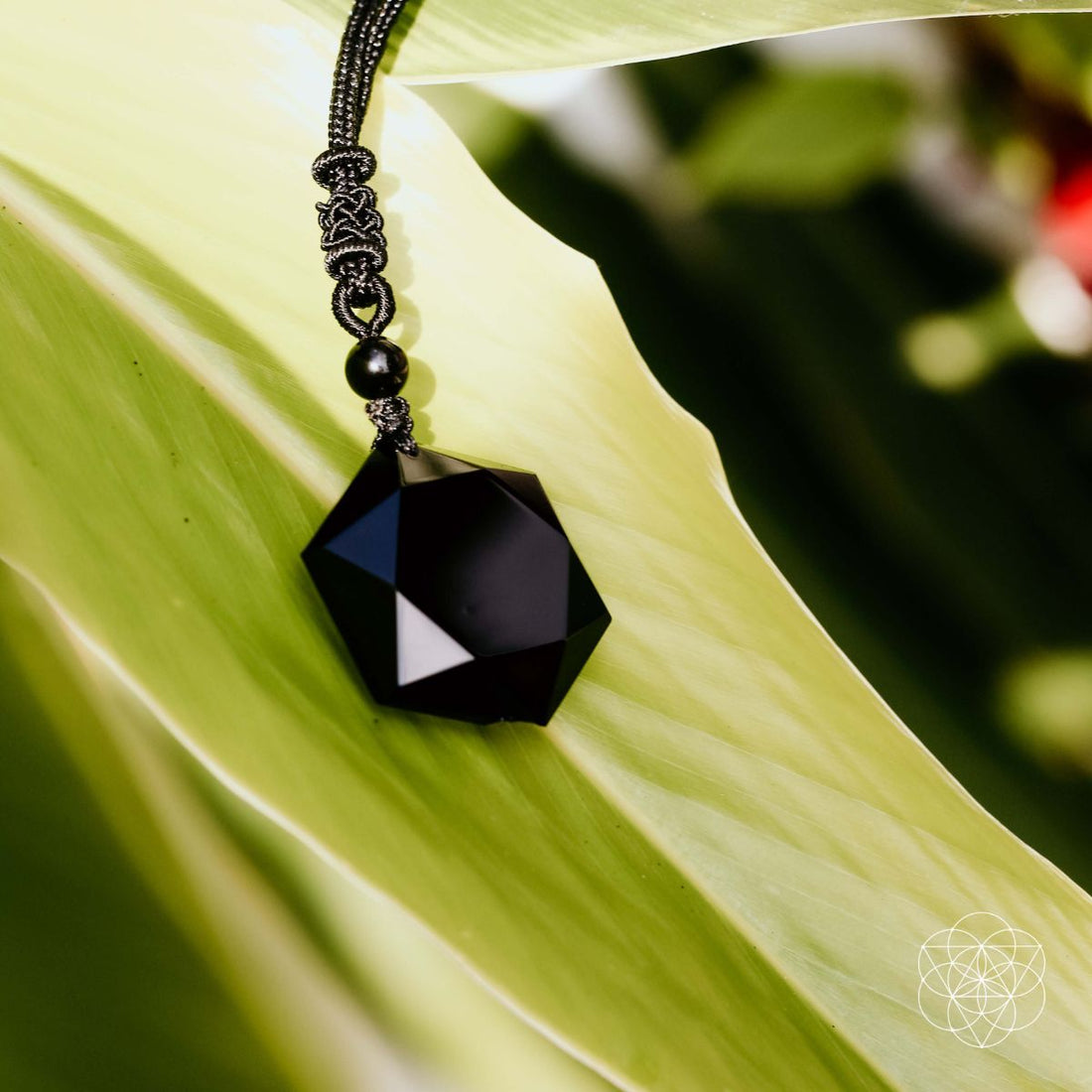Black obsidian pendant necklace featuring a polished talisman, designed by Conscious Items in a sleek, premium black stone.