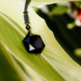 Black obsidian pendant necklace featuring a polished talisman, designed by Conscious Items in a sleek, premium black stone.