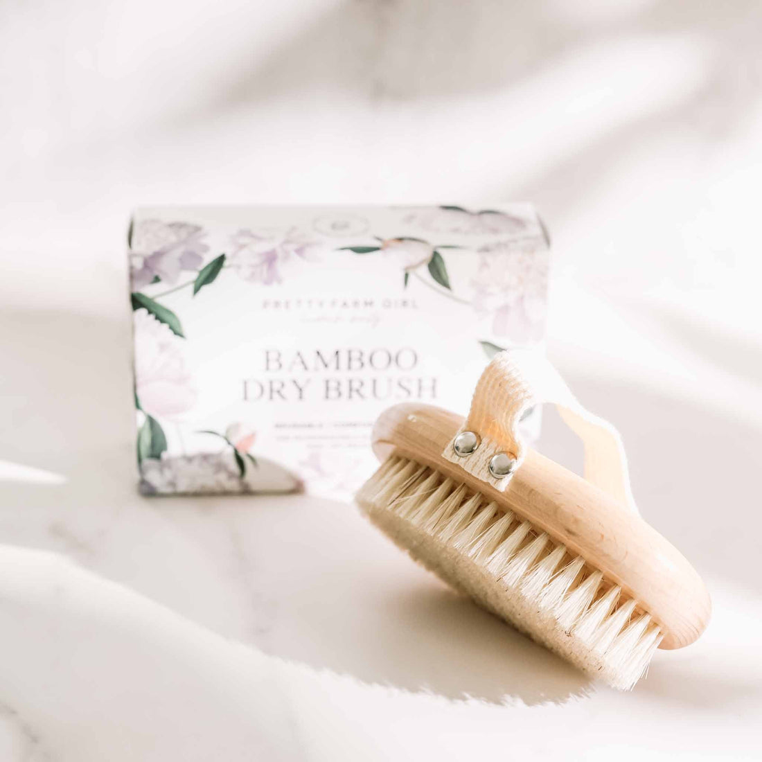 Pretty Farm Girl dry body brush, natural exfoliating skincare accessory with wooden handle and bristles for gentle daily use.