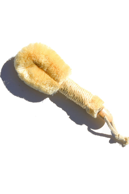 Pretty Farm Girl sisal exfoliating dry brush for skincare, featuring natural bristles and ergonomic handle for gentle exfoliation.