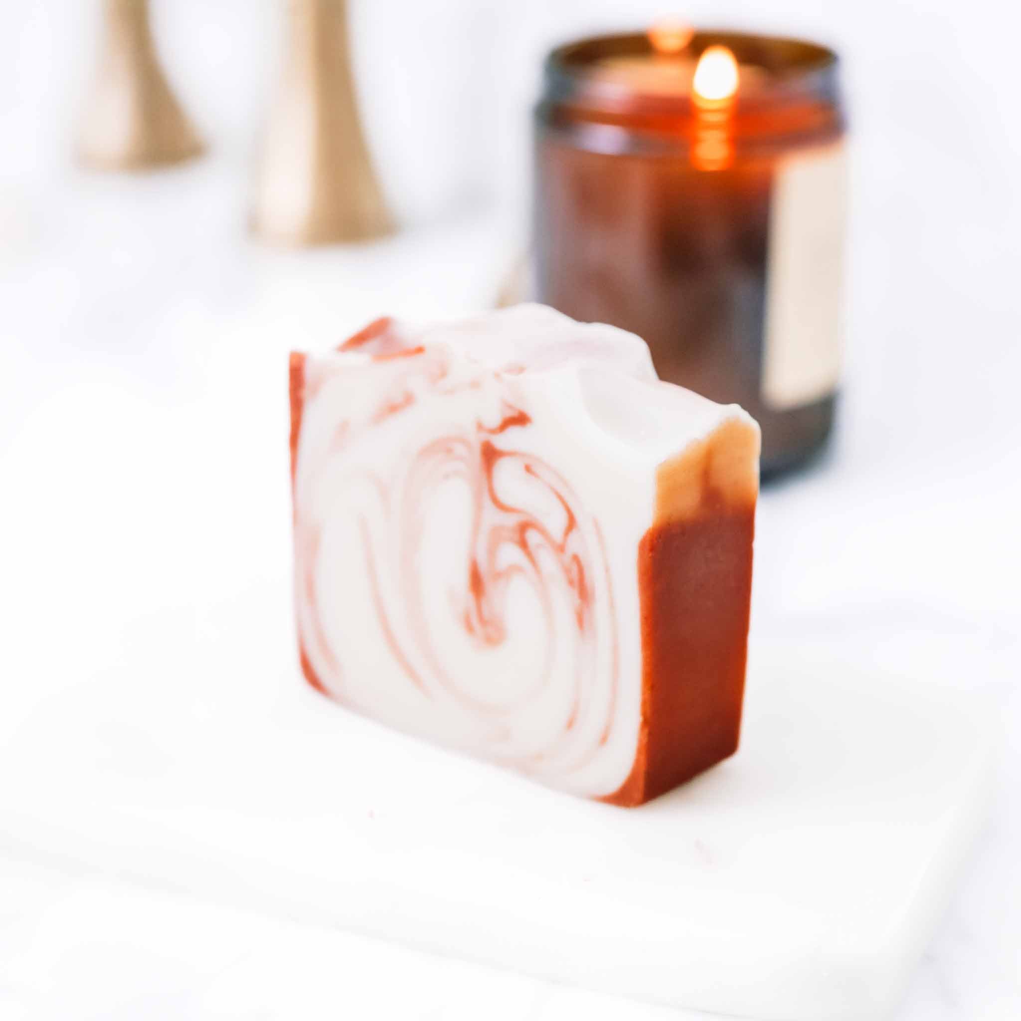 Handmade citrus cedarwood soap bar with tallow and goat milk, featuring a natural, textured appearance and rustic packaging.