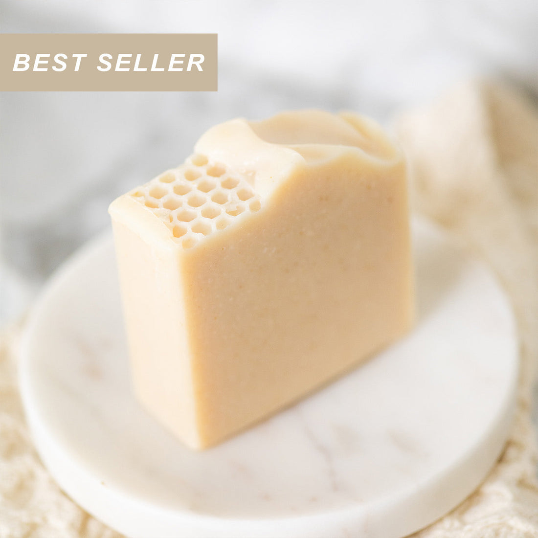 Handmade tallow and goat milk soap bar by Pretty Farm Girl with a milk and honey fragrance-free label showing natural skincare ingredients.