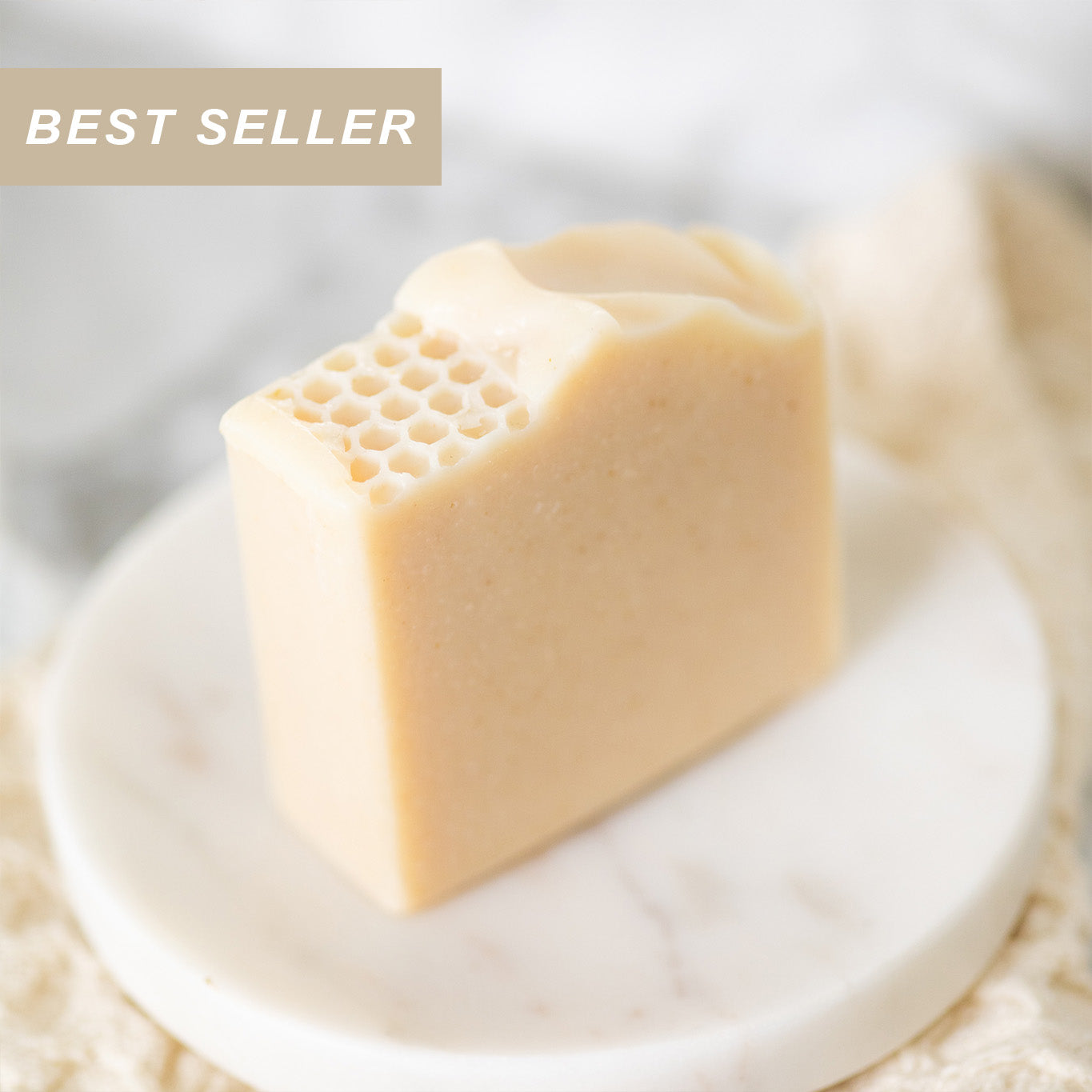 Handmade tallow and goat milk soap bar by Pretty Farm Girl with a milk and honey fragrance-free label showing natural skincare ingredients.