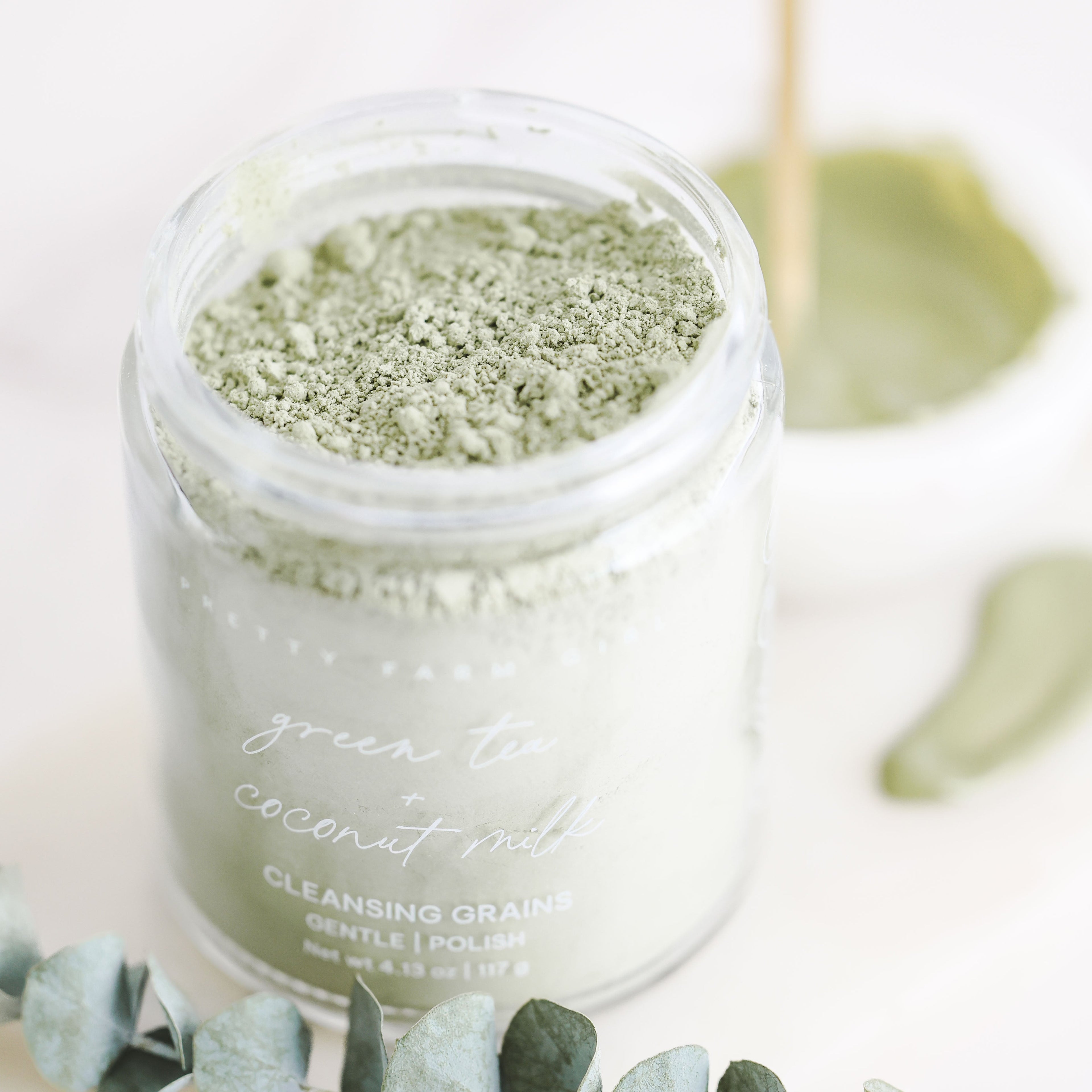 Pretty Farm Girl Green Tea and Coconut Milk Facial Cleansing Grains in a jar, showcasing natural exfoliating facial cleansing product.
