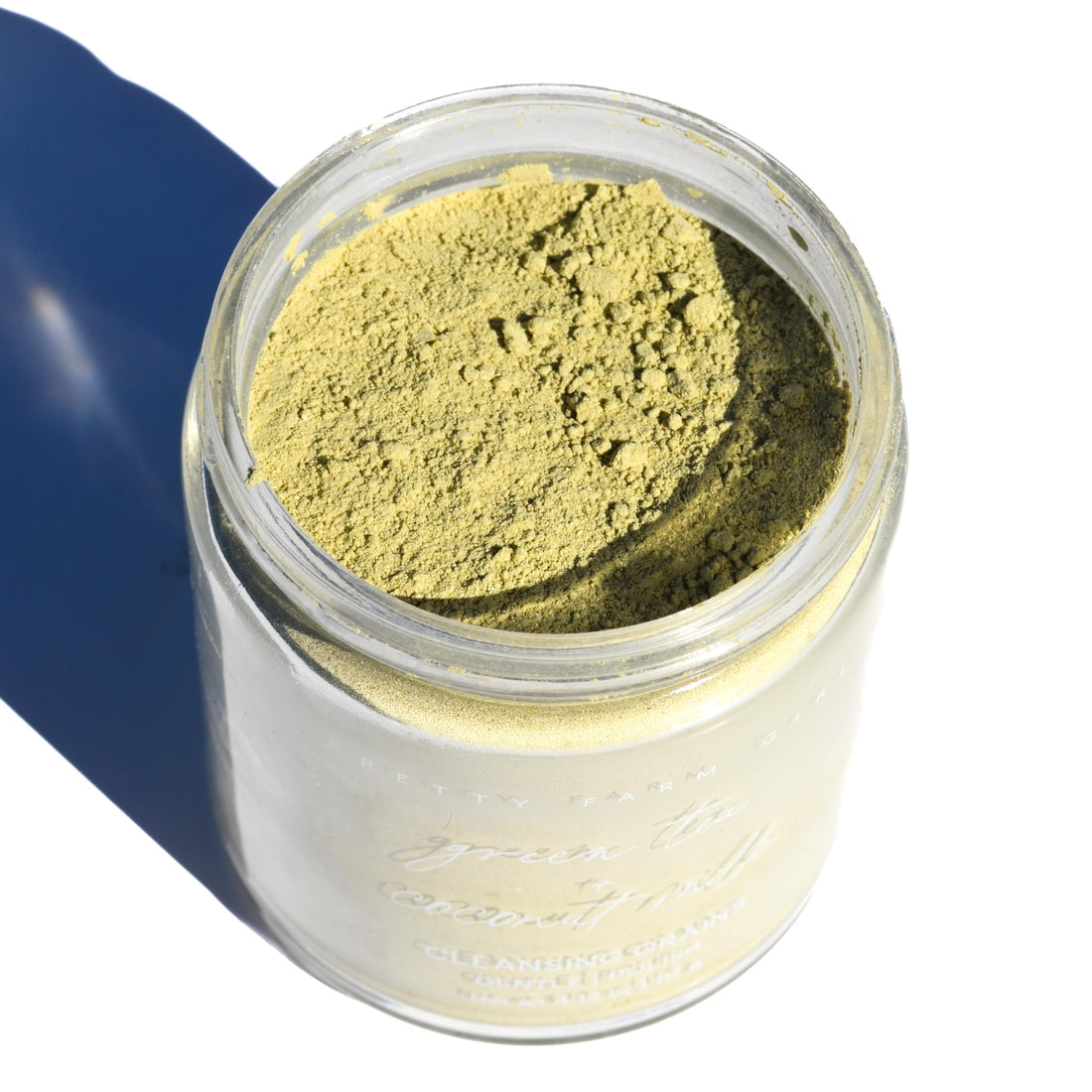 Green tea and coconut milk facial cleansing grains by Pretty Farm Girl, showing the green tea top in the jar.