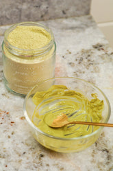 Pretty Farm Girl green tea and coconut milk facial cleansing grains in a jar, showing the natural textured product.