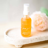 Pretty Farm Girl Farm Girl Cleansing Oil face cleanser, showing a clear bottle with pump dispenser and natural ingredients.