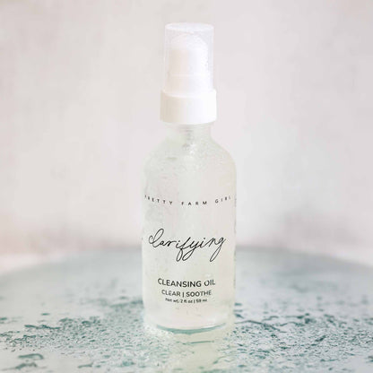 Pretty Farm Girl clarifying cleansing oil for acne-prone skin, featuring a bottle of face cleanser with natural ingredients.