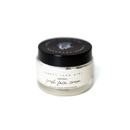 Pretty Farm Girl Fresh Face Cream anti-aging moisturizer in a white jar, featuring natural ingredients and smooth, creamy texture.