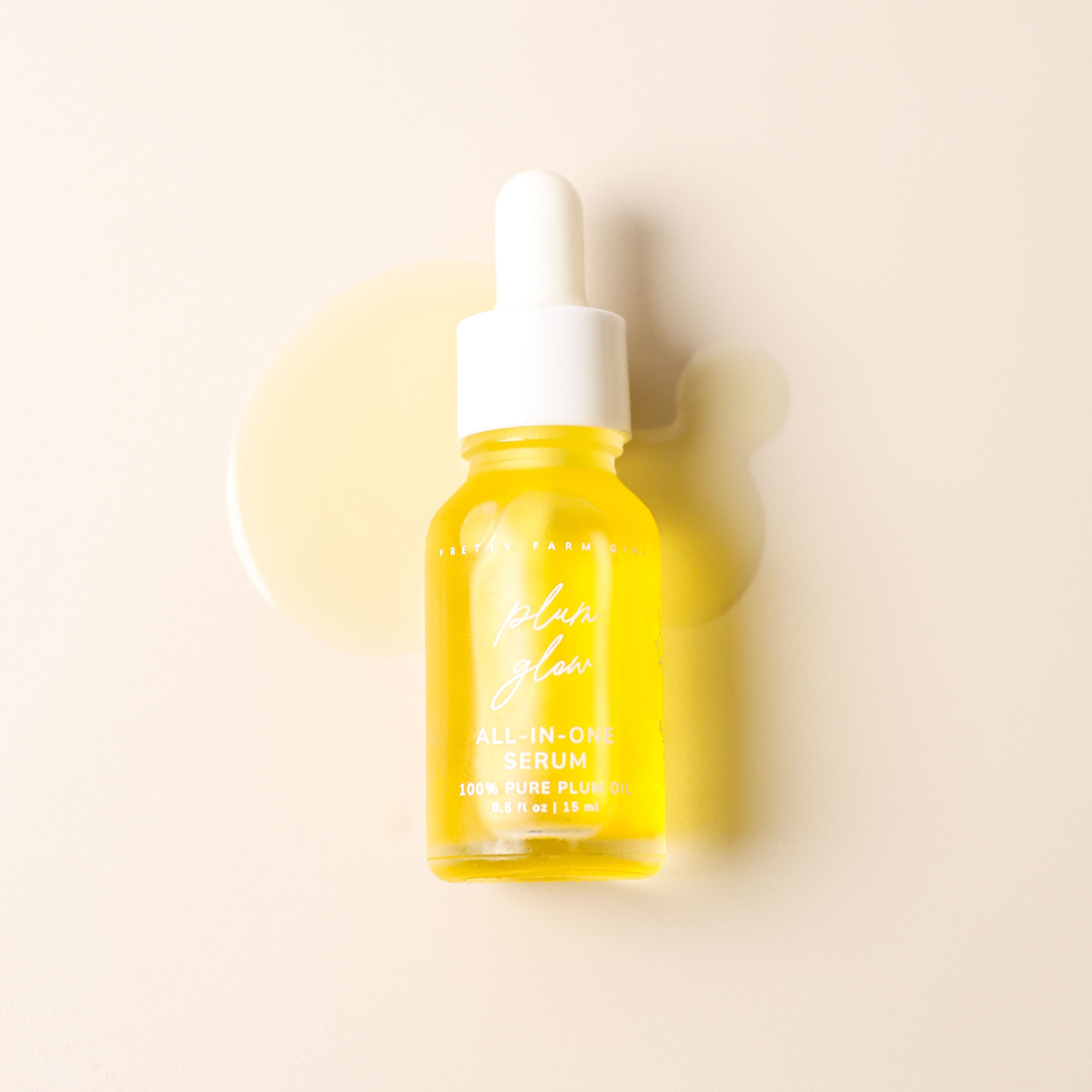 Pretty Farm Girl Plum Glow Multipurpose Face Serum with 100% pure plum oil, featuring a clear glass bottle and dropper applicator.