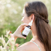 Bottle of Pretty Farm Girl Lush Locks Batana Hair Oil for natural hair care, showing the product in a clear, attractive container.