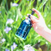 Blue Bloom Botanical Body Oil by Pretty Farm Girl, featuring a sleek bottle with botanical ingredients and a calming blue label.