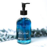 Blue Bloom Botanical Body Oil by Pretty Farm Girl, featuring a sleek blue bottle with floral botanical ingredients, ideal for skin hydration.