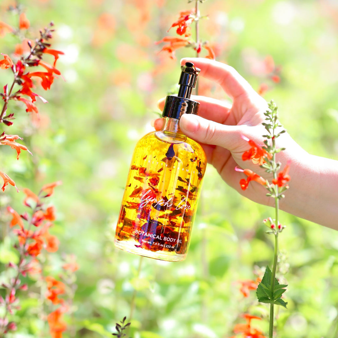 Pretty Farm Girl Lymph Love Body Oil for Massage, featuring a sleek bottle with natural ingredients for health and beauty use.