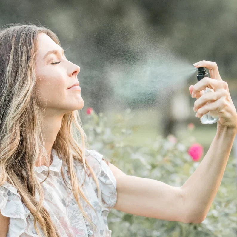 Pretty Farm Girl Organic Pure Rose Facial Toner in a spray bottle, featuring a clear liquid and rose petal design on the label.