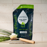 Puracy dish soap refill bottle with natural ingredients, designed for effective cleaning of dishes and kitchenware.