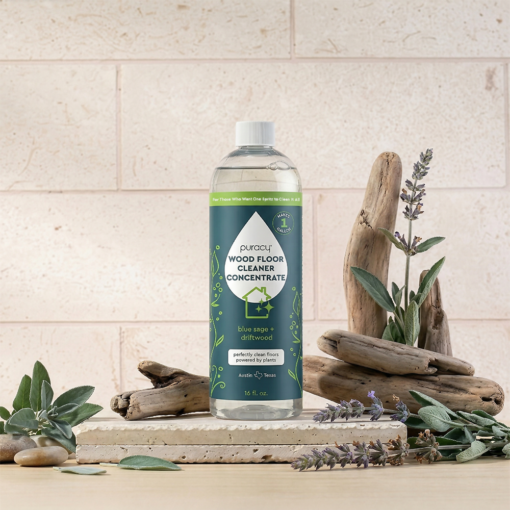 Puracy Everyday Multi-Surface Cleaner in a 16oz bottle, designed for cleaning wood floors and various surfaces with a blue sage and driftwood scent.