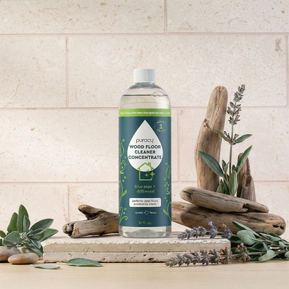 Puracy Everyday Multi-Surface Cleaner in a 16oz bottle, designed for cleaning wood floors and various surfaces with a blue sage and driftwood scent.