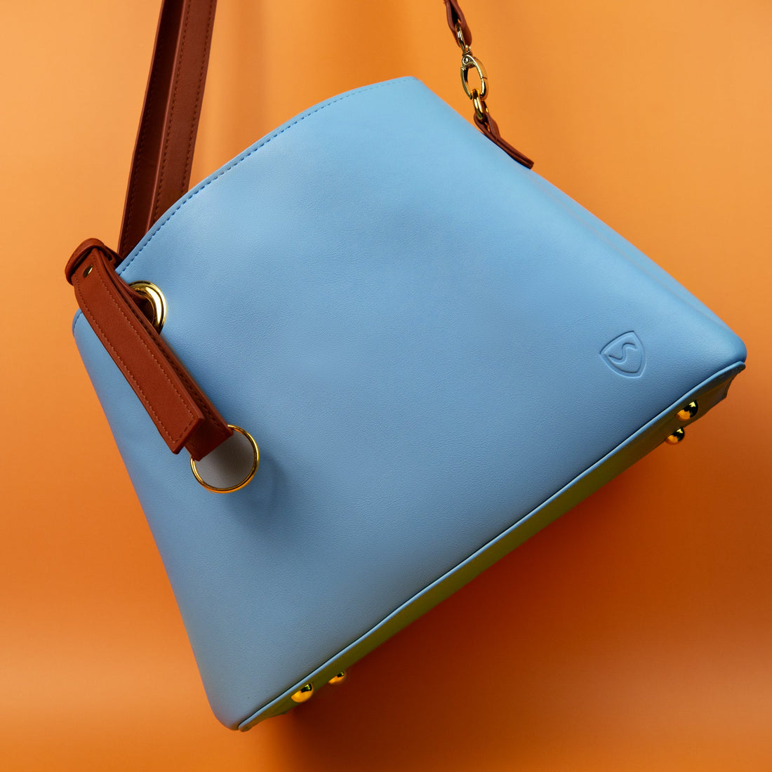 Orange Shield Your Body SYB purse for mobile phones, stylish accessory with secure hanging design, on a neutral background.