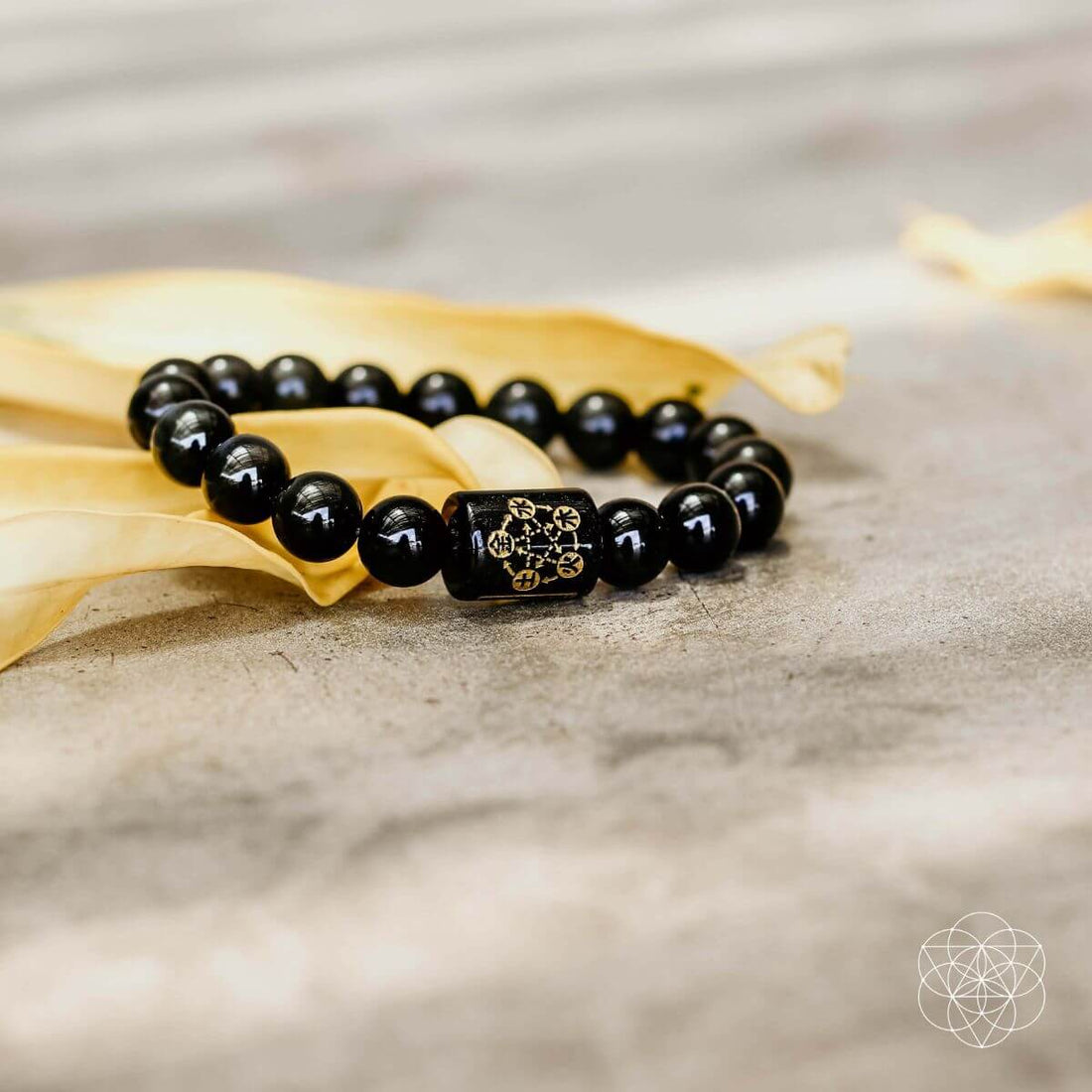 Rainbow Obsidian Protection Bracelet by Conscious Items featuring multicolored polished stones on an elastic band.
