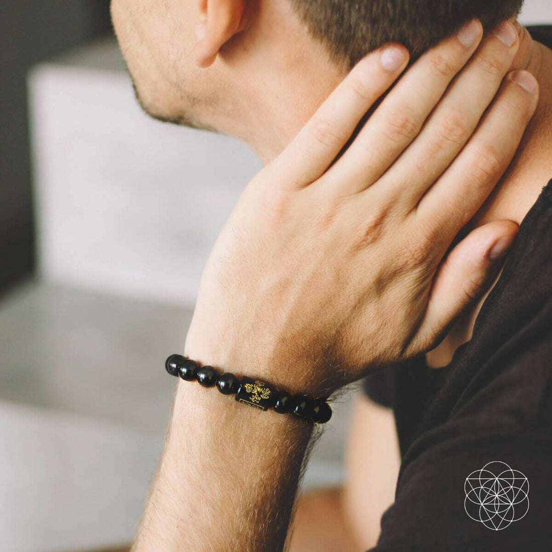 Rainbow Obsidian Protection Bracelet from Conscious Items featuring colorful polished stone beads on an elastic band.