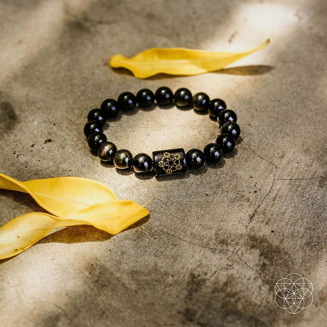 Rainbow Obsidian Protection Bracelet by Conscious Items featuring vibrant rainbow-colored polished stones and adjustable cord.