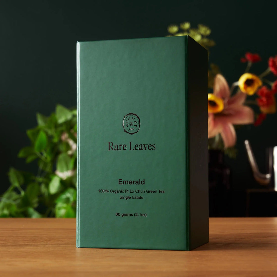 Single estate Pi Lo Chun green tea from Rare Leaves Emerald by August Uncommon Tea, fresh green tea leaves in a rustic box.