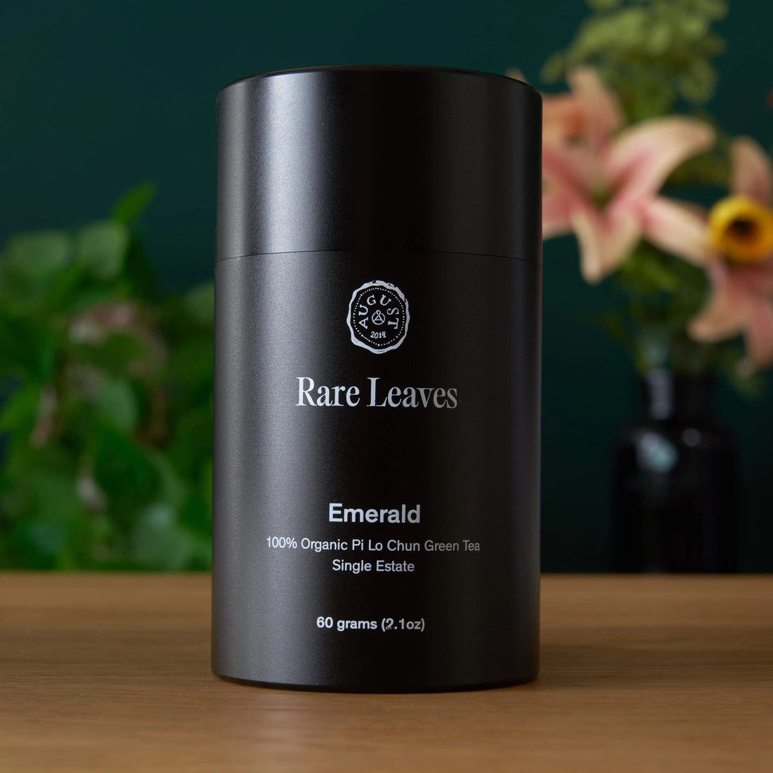 Front of tin containing Rare Leaves Emerald Pi Lo Chun green tea by August Uncommon Tea, showcasing the tea packaging.