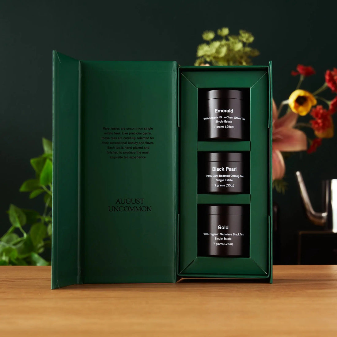 Open tin of Rare Leaves Single Origin Tea Sampler by August Uncommon Tea, showcasing assorted tea leaves inside.