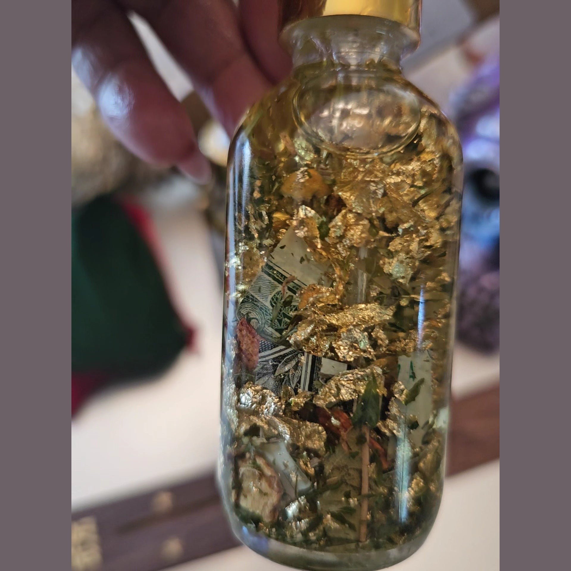 Rich Bitch Conjure Fast Money Oil in a small glass bottle with a gold cap, used for attracting quick cash and prosperity.