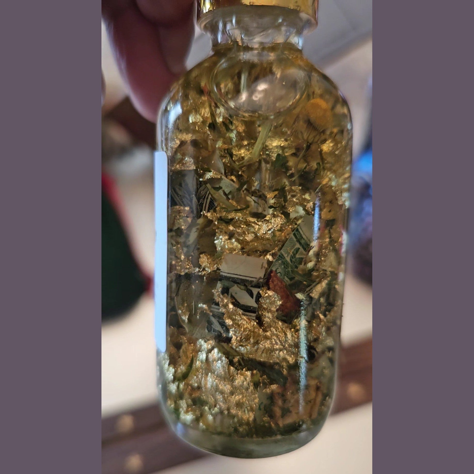 Rich Bitch Conjure Fast Money Oil in a small glass bottle with a black cap, used for attracting quick cash and prosperity.