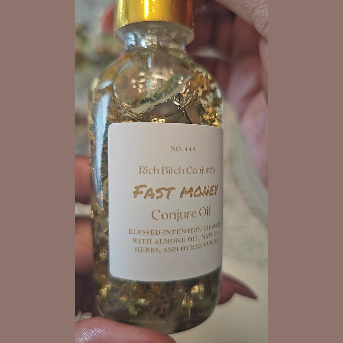 Rich Bitch Conjure Fast Money Oil in a small glass bottle, designed for quick cash and prosperity in hoodoo conjure practices.
