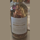 Rich Bitch Conjure Hoodoo oil bottle labeled Honey Luxe Conjure Oil, a luxury love and prosperity blend in a dark glass bottle.