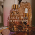 Rich Bitch Conjure Lucky Girl Sweetening Hoodoo Oil in a small glass bottle with a white label on a minimalist background.