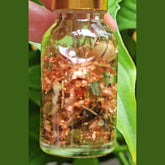 Rich Bitch Conjure Lucky Girl Hoodoo Oil in a small glass bottle with a black screw cap, labeled as good luck, prosperity, and favor oil.