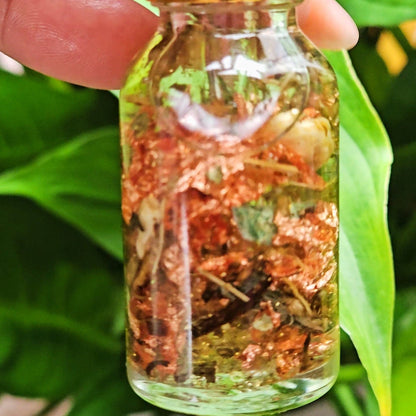 Rich Bitch Conjure Lucky Girl Sweetening Hoodoo Oil in a small glass bottle with a black cap, labeled for good luck and prosperity rituals.