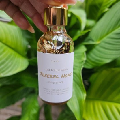 Rich Bitch Conjure Jezebel Honey Oil bottle, natural hoodoo oil with honey infusion, in a clear glass container with a dropper top.