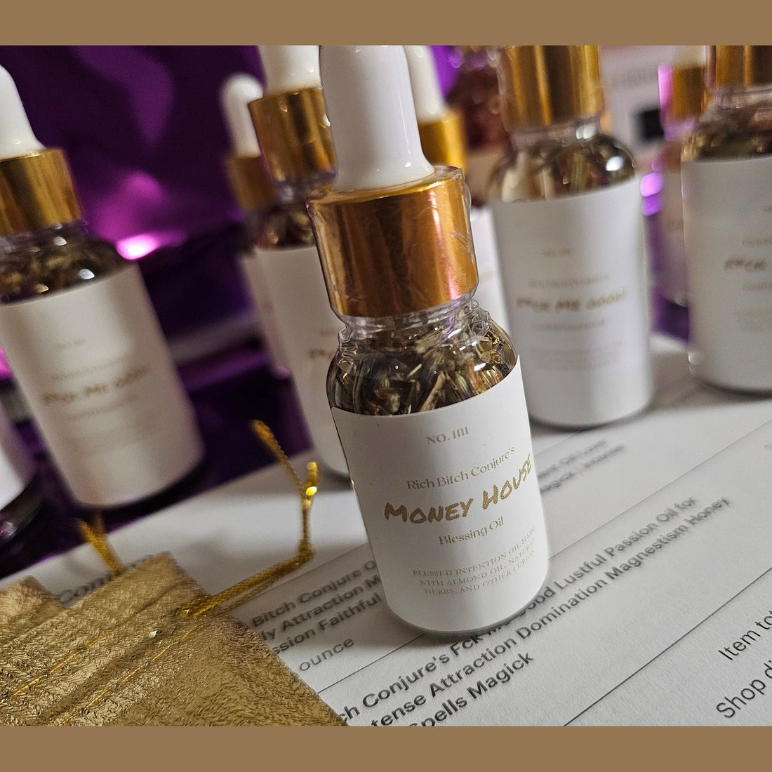 Rich Bitch Conjure hoodoo money house blessing oil in a small glass bottle with a black cap, used for spiritual prosperity rituals.