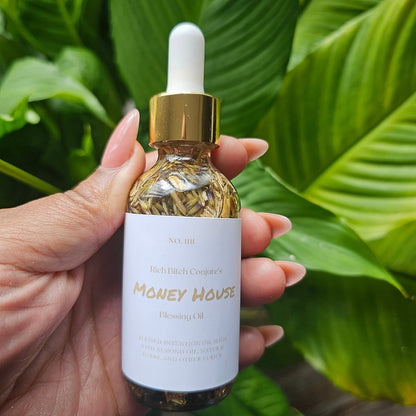 Rich Bitch Conjure Money House Blessing Oil in a small glass bottle with a dropper, used for hoodoo rituals.