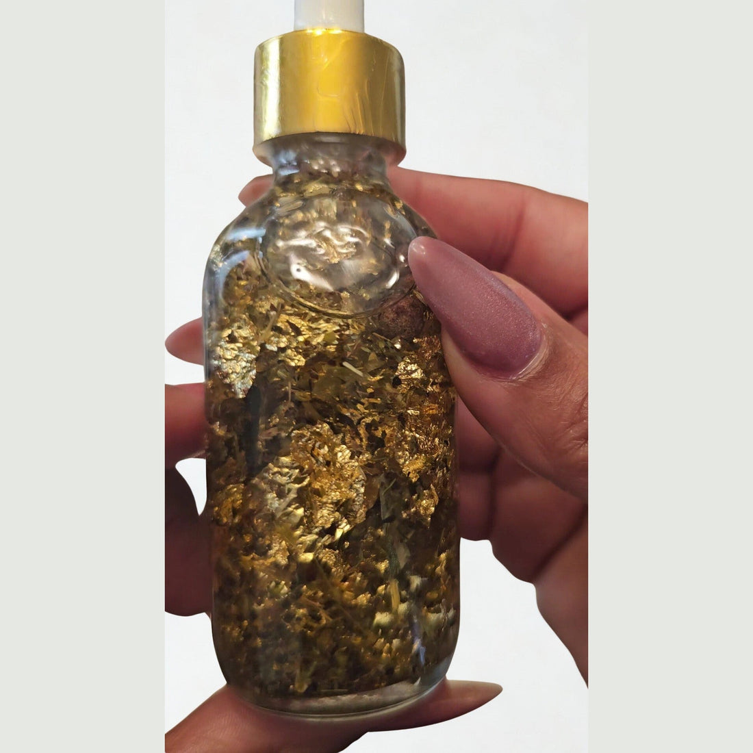 Rich Bitch Conjure Hoodoo Oil for money attraction, wealth, and prosperity rituals, shown in a small glass bottle with herbal ingredients.